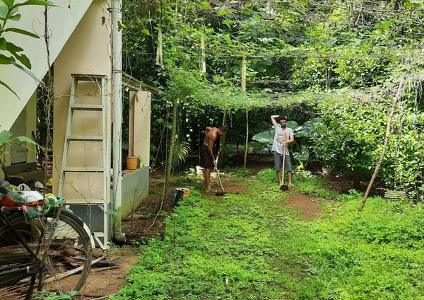 Image of me working with my father, in the green lush of Kerala